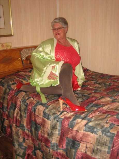 Fat granny Girdle Goddess pets her femininity after stripping to hosiery on her bed