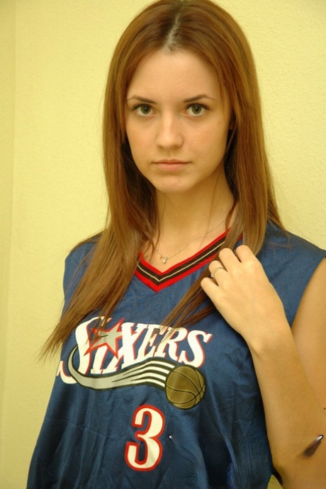 Young cheerleader Amy lifts her uniform to tease with alluring panties & underboob