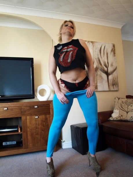 Mature BBW Daniella English frees her bush from yoga pants and thong panties