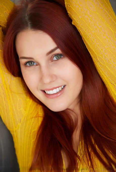 Alluring redhead Charlie Red bares her phat curves and bald slit in a dining room