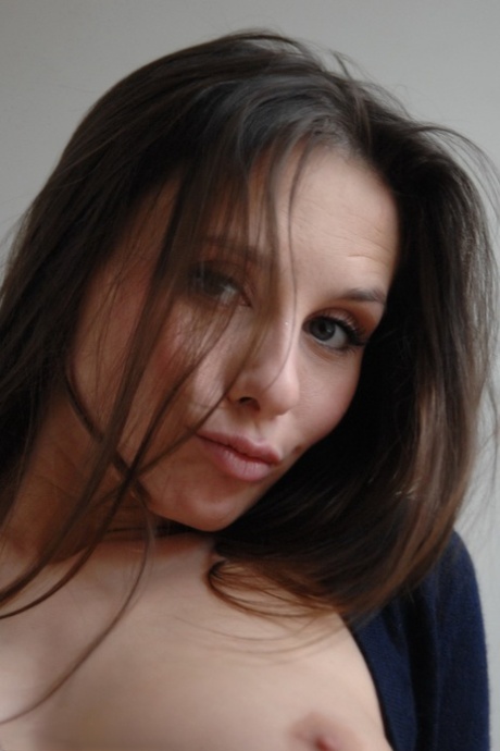 Beautiful female with firm breasts and a flat stomach frees her curves from jeans