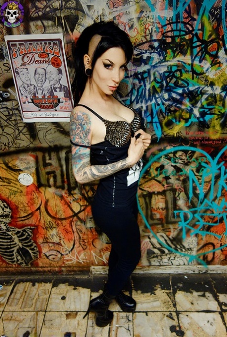 Goth girl Razor Candi strips to OTK boots in graffiti filled bathroom