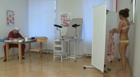 Redheaded young adult Lara takes her gyno's stiff rod from behind at the clinic