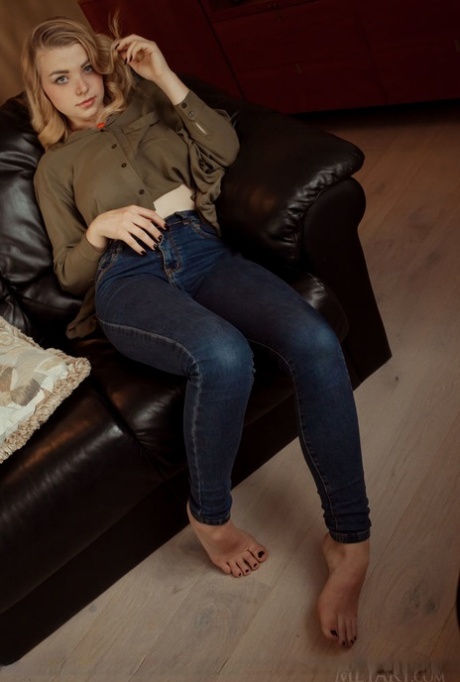 Young solo girl Daniel Sea uncovers her nice breasts and shaved femininity