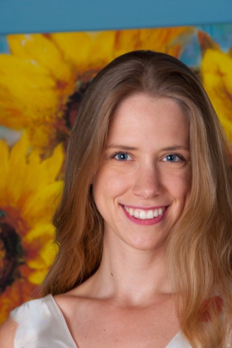 Smiley blue eyed April flashes her hairy femininity and spreads natural on her bed