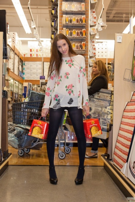 Naughty skinny chick Belle Knox flashes breasts and curves in the local store