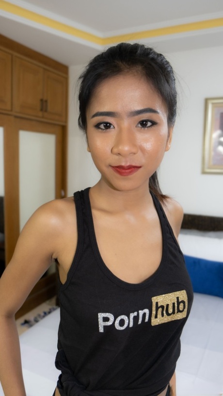 Thai beauty Som poses in her PornHub outfit & shows her big breasts & curves