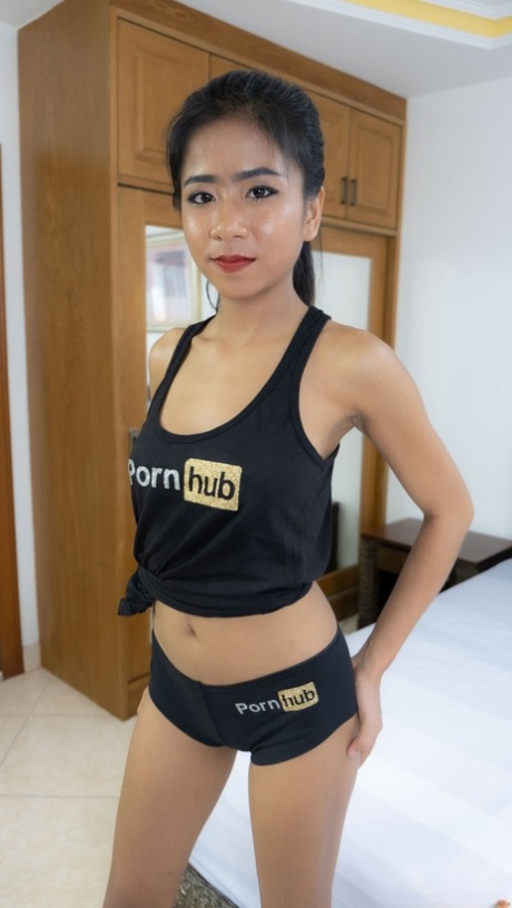 Thai beauty Som poses in her PornHub outfit & shows her big breasts & curves
