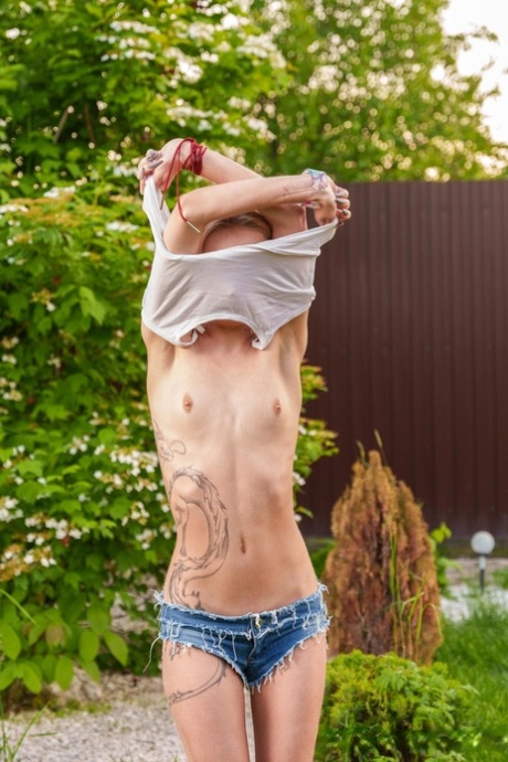 Slender European young adult Tea Mint flaunts her tiny breasts and masturbates outdoors