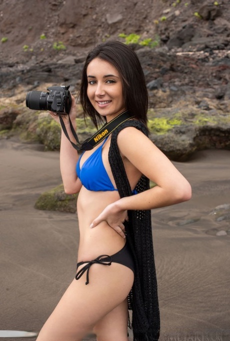 Nice young adult girl Dionisia gets completely natural while shooting on a beach