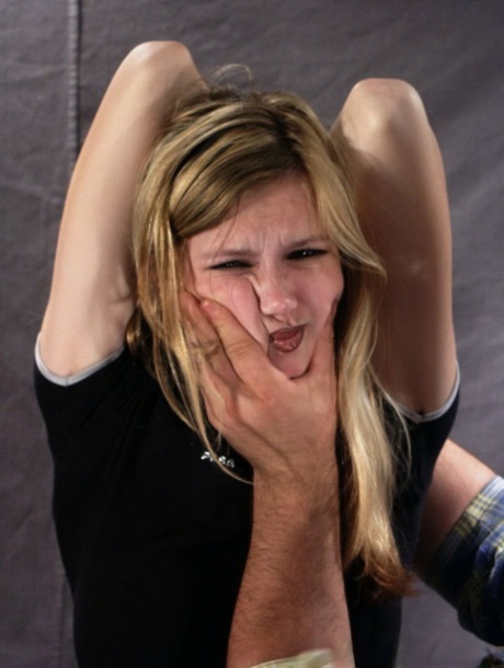 Restrained blonde girl is forced into having to smoke a cigarette