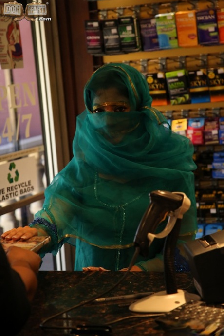 Attractive Muslim babe Nadia Ali strips at a gloryhole and sucks a huge black manhood