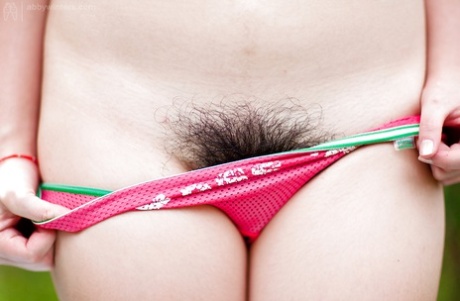 Hairy Asian authentic Gita slowly taking off her clothes outdoors