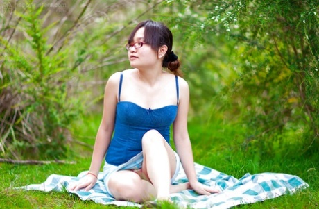 Hairy Asian authentic Gita slowly taking off her clothes outdoors