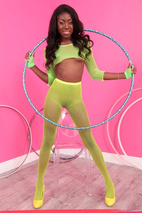 Slim black girl Anne Amari exposes her tiny titties and yummy curves in a solo