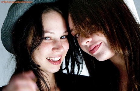 Young adult girls Carly T and Rebekah strip off ripped denim jeans to model artistic