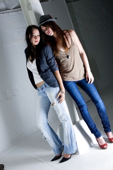 Young adult girls Carly T and Rebekah strip off ripped denim jeans to model artistic