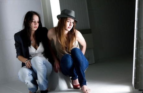 Young adult girls Carly T and Rebekah strip off ripped denim jeans to model artistic