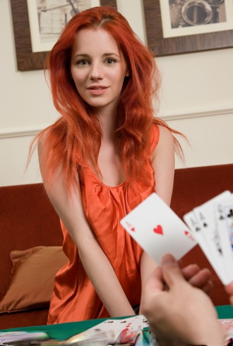 Attractive redhead Ariel removes clothes after losing at poker & rolls in the chips