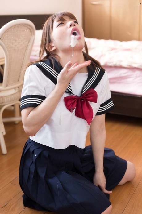 Japanese schoolgirl spits out climax after sucking off two cocks