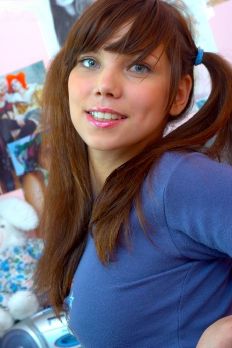 Cute young adult pulls down pink fishnets before masturbating in pigtails