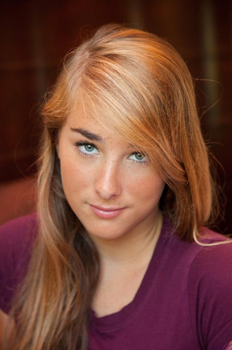 Athletic young adult Nicole Carver shows off toned body and attractive round curves at home.