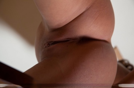 Pretty brunette Penelopea bares her small breasts & bends to show her tiny curves