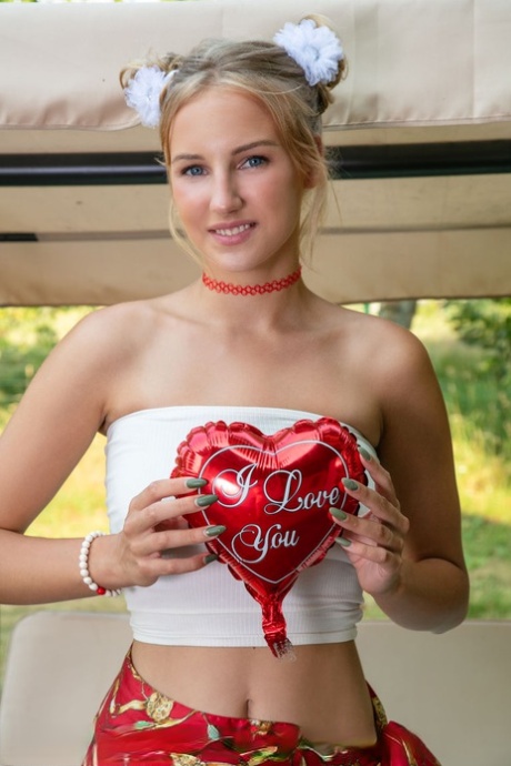Beautiful blonde young adult Nana gets natural on a bench swing while wearing a choker