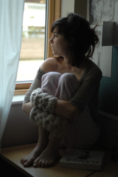 Thin young adult Estelle K gets natural in fingerless gloves while reading a Manga book