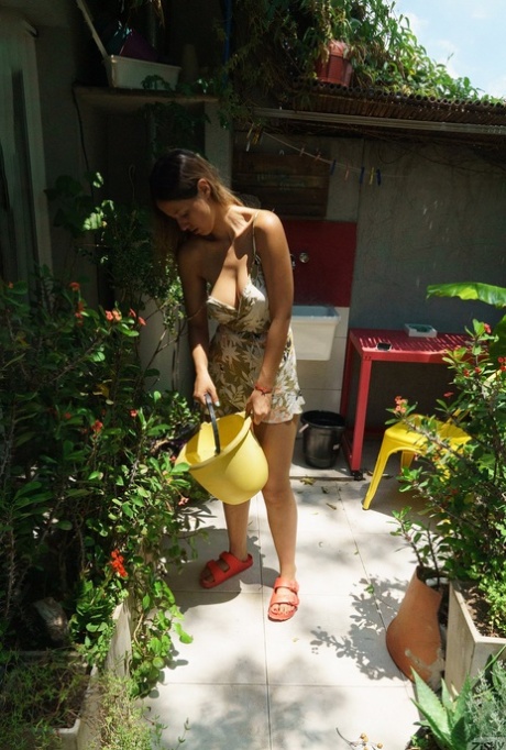 Pretty babe Agos Firenze shows her big breasts with puffy nipples outdoors