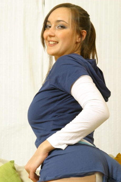 Cute young adult babe Nadia E disrobes to bare her breasts & tease in panties & nylons