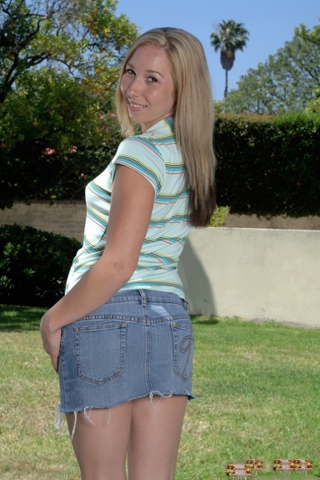 Attractive young adult flashes nice breasts outdoors and fingers her horny femininity on her knees