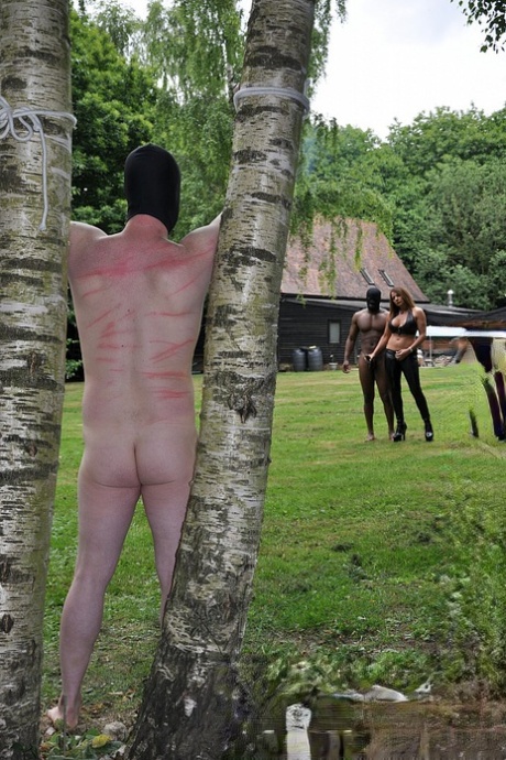 Femdom Mistress Carly ties hubby up in the yard to watch her get fucked