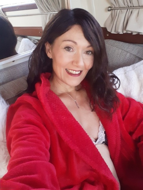 Alluring MATURE WOMAN Kitty Cream models for a non-nude shoot while at home and alone