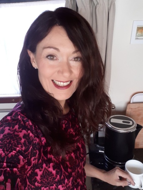 Alluring MATURE WOMAN Kitty Cream models for a non-nude shoot while at home and alone