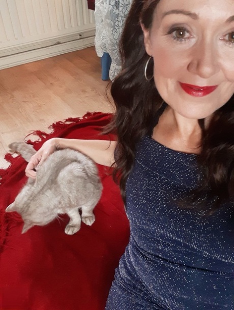 Alluring MATURE WOMAN Kitty Cream models for a non-nude shoot while at home and alone