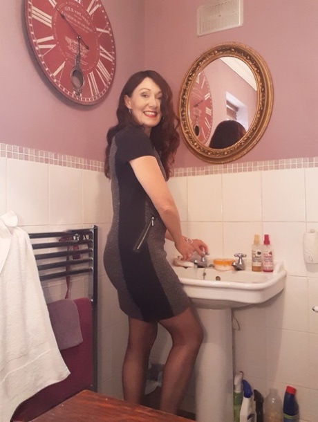 Alluring MATURE WOMAN Kitty Cream models for a non-nude shoot while at home and alone