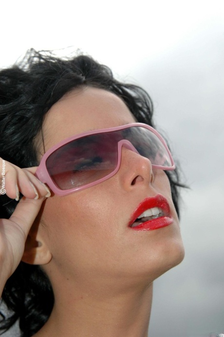 Alluring model with sunglasses Tacha showing off her attractive body in black boots