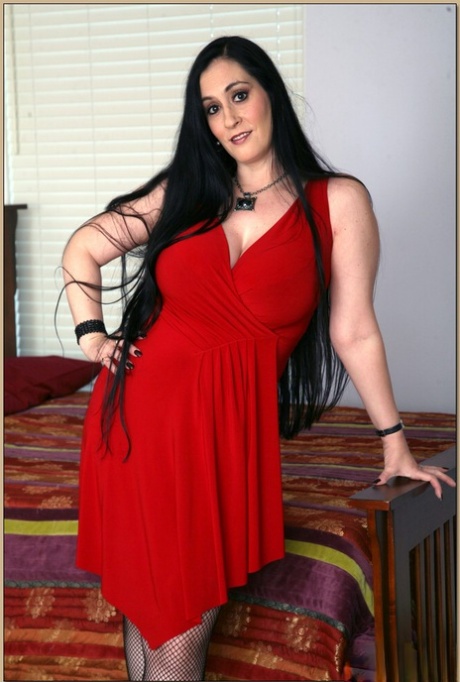 Plumper mom in fishnet stockings revealing puffy hooters and curves