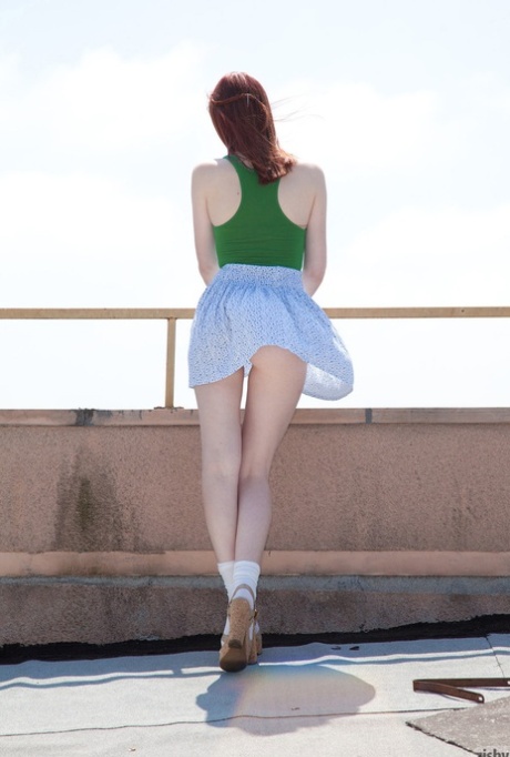 Slim redhead young adult Haley Gladwell strips to her bodysuit and flaunts her curves