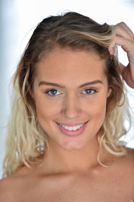 Gorgeous blonde Athena reveals her perfect melons and poses artistic on a chair