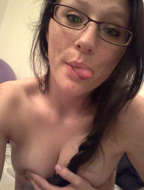 Geeky brunette Freckles 18 touches her attractive breasts in her solo homemade session