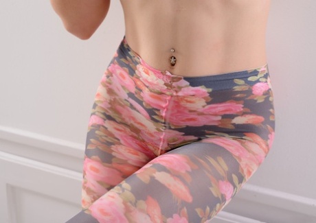 Caucasian girl slips leggings over butt plug adorned curves in black pumps