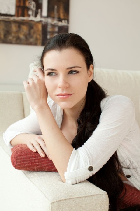 Pretty brunette with gorgeous face Valeria A lounging on sofa in the artistic