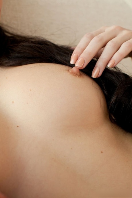 Pretty brunette with gorgeous face Valeria A lounging on sofa in the artistic