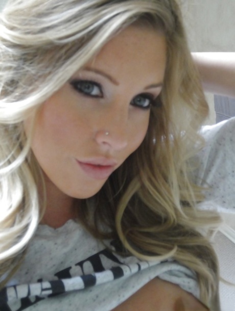 Young blonde Samantha Saint taking artistic selfies in the bathroom