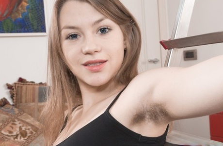Young young adult Kira Tomson lifts her tartan skirt to touch her super hairy twat