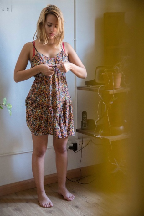 Natural white chick pulls on her bra and panties as she gets dressed