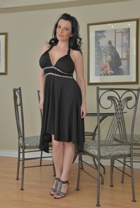 Brunette MATURE WOMAN Stacy Ray exposing large breasts and alluring legs in high heels