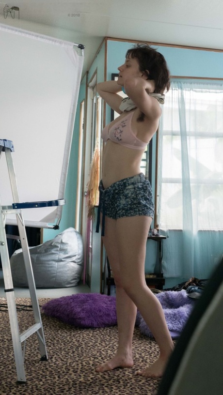 Slender Charlee shows nice breasts and thick underarm hair while getting dressed